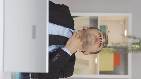 Vertical-video-of-Home-office-worker-man-suffering-from-sore-throat.